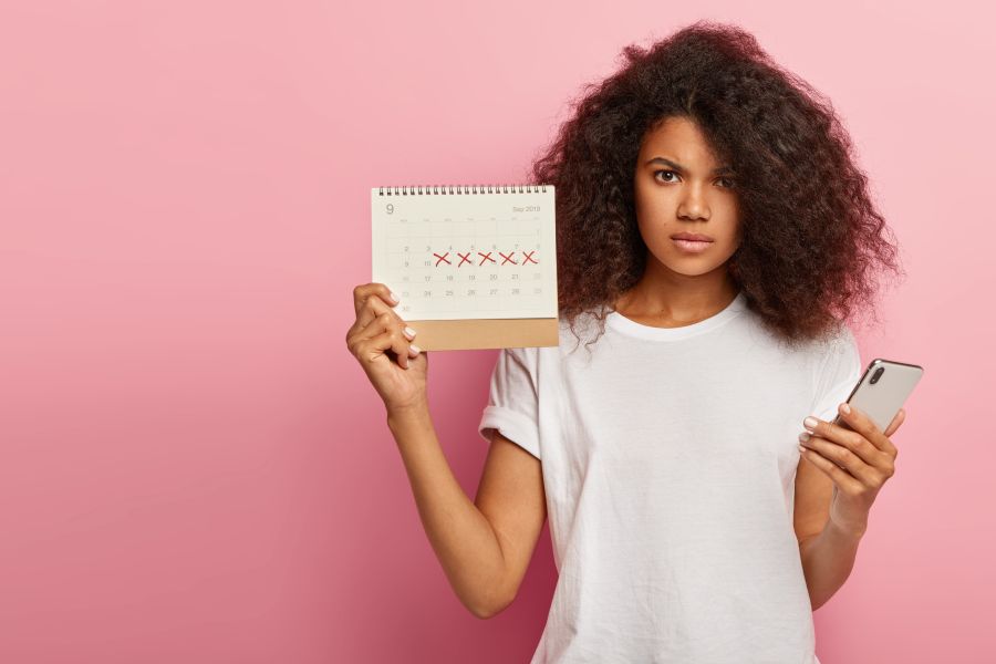teen holds up calendar